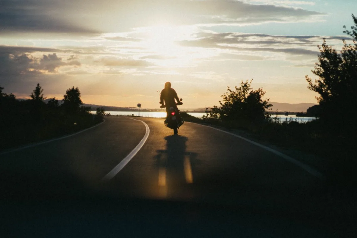 a person riding a motorcycle on a road